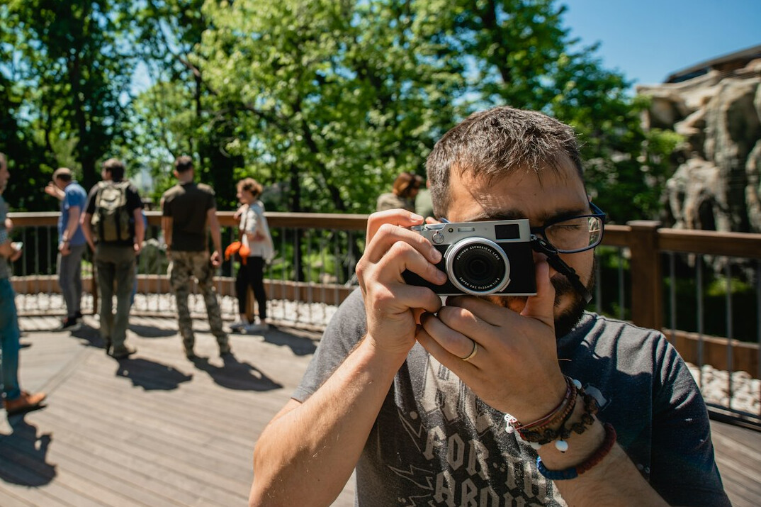 Photography workshop participants learning with cameras outdoors