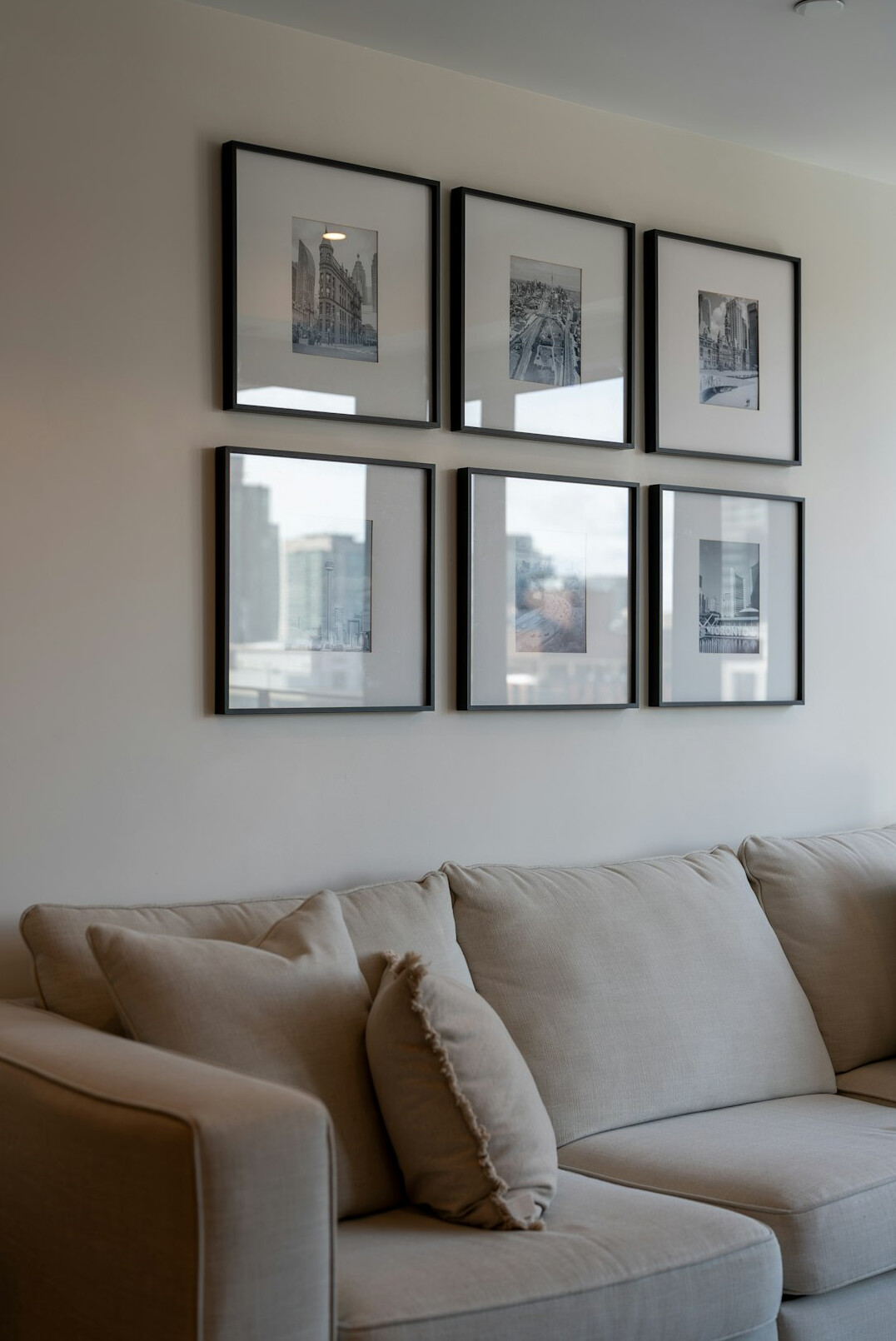 Framed black and white photographs displayed on a gallery wall