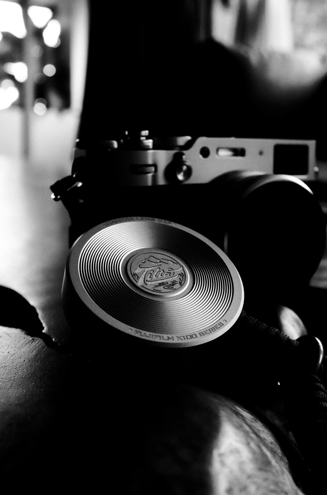 Photographer editing black and white photographs on a laptop in a studio