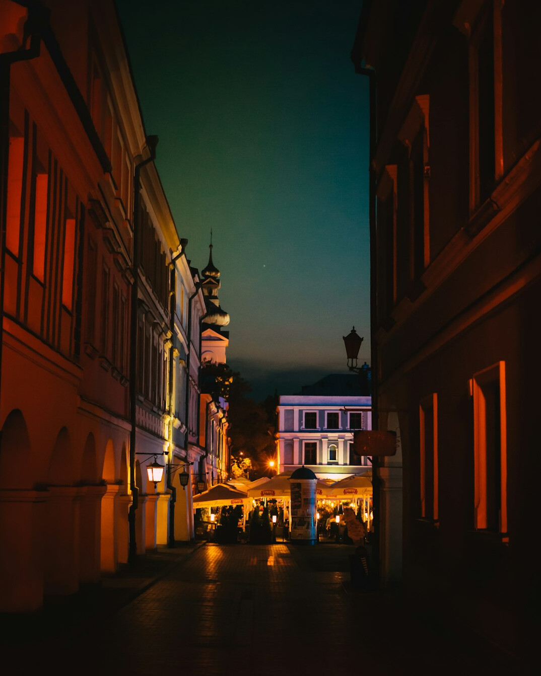 Documentary photographer taking a photo on a street in a small Polish town